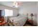 Bedroom with brass bed frame and ceiling fan at 17475 W Caribbean Ln, Surprise, AZ 85388