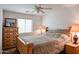 Bedroom with wooden bed frame and ample storage at 17475 W Caribbean Ln, Surprise, AZ 85388