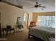 Spacious Primary bedroom with large window and ceiling fan at 17475 W Caribbean Ln, Surprise, AZ 85388