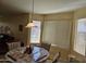 Bright dining area with corner window and pendant lighting at 17475 W Caribbean Ln, Surprise, AZ 85388