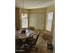Cozy dining area with a round table and three windows at 17475 W Caribbean Ln, Surprise, AZ 85388