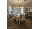 Bright dining room features a table with seating for six and a lovely chandelier at 17475 W Caribbean Ln, Surprise, AZ 85388