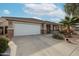 One-story house with a white garage door and stone accents at 17475 W Caribbean Ln, Surprise, AZ 85388