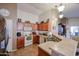 Kitchen with wood cabinets, tiled floors and a breakfast bar at 17475 W Caribbean Ln, Surprise, AZ 85388