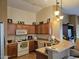 Kitchen with wood cabinets, appliances, and a breakfast bar at 17475 W Caribbean Ln, Surprise, AZ 85388