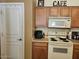 Well-equipped kitchen with wood cabinets and a built-in microwave at 17475 W Caribbean Ln, Surprise, AZ 85388