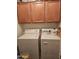 Laundry room with washer, dryer, and overhead cabinets at 17475 W Caribbean Ln, Surprise, AZ 85388