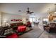 Spacious living room with leather furniture and tile flooring at 17475 W Caribbean Ln, Surprise, AZ 85388