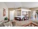 Bright living room with tiled floors and a cozy seating area at 17475 W Caribbean Ln, Surprise, AZ 85388