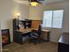 Home office with corner desk, window, and chair at 17475 W Caribbean Ln, Surprise, AZ 85388