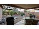 Covered patio with seating area and grill at 17475 W Caribbean Ln, Surprise, AZ 85388