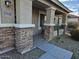 Covered porch with stone accents and a metal railing at 17475 W Caribbean Ln, Surprise, AZ 85388