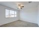 Bright bedroom with ceiling fan and large window at 4528 N 91St Dr, Phoenix, AZ 85037