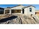 New construction home with a neutral color palette and unfinished landscaping at 46940 W Old Timer Rd, Maricopa, AZ 85139