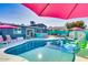 Inviting backyard oasis with a sparkling pool, patio, and vibrant landscaping at 602 E Taylor St, Tempe, AZ 85288