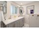 Double vanity bathroom with gray cabinets and gold accents at 602 E Taylor St, Tempe, AZ 85288