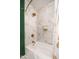 Clean bathroom featuring a bathtub, marble tile, and gold fixtures at 602 E Taylor St, Tempe, AZ 85288