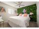 Bright bedroom with a king-size bed and a lush green wall at 602 E Taylor St, Tempe, AZ 85288