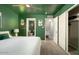 Bright bedroom with vibrant green walls, a glimpse into the bathroom, and a modern pineapple-themed decor at 602 E Taylor St, Tempe, AZ 85288