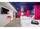 Large bedroom featuring three beds, television, and pink curtains at 602 E Taylor St, Tempe, AZ 85288