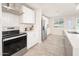 Sleek kitchen with white cabinets, stainless steel appliances, and tile flooring at 602 E Taylor St, Tempe, AZ 85288