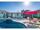 Spacious pool and patio area with lounge chairs and red umbrella at 602 E Taylor St, Tempe, AZ 85288