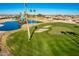 Aerial view of the golf course community with a lake and houses at 9048 E Cedar Waxwing Dr, Sun Lakes, AZ 85248
