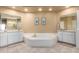Large bathroom with double vanity, a soaking tub and tile flooring at 9048 E Cedar Waxwing Dr, Sun Lakes, AZ 85248