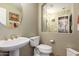 Clean bathroom with pedestal sink, toilet and a mirrored medicine cabinet at 9048 E Cedar Waxwing Dr, Sun Lakes, AZ 85248