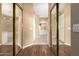 Walk-in closet with mirrored doors and wood flooring at 9048 E Cedar Waxwing Dr, Sun Lakes, AZ 85248