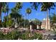 Community clubhouse with palm trees and landscaping at 9048 E Cedar Waxwing Dr, Sun Lakes, AZ 85248