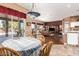Bright dining area with wood table and chairs, view to backyard at 9048 E Cedar Waxwing Dr, Sun Lakes, AZ 85248