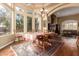 Spacious dining room with hardwood floors, large windows and a formal dining table at 9048 E Cedar Waxwing Dr, Sun Lakes, AZ 85248
