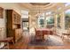 Sunlit dining room with hardwood floors, large windows, and a beautiful chandelier at 9048 E Cedar Waxwing Dr, Sun Lakes, AZ 85248