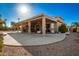 Home exterior showcasing large covered patio and landscaping at 9048 E Cedar Waxwing Dr, Sun Lakes, AZ 85248