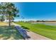 Golf course path with pond and trees at 9048 E Cedar Waxwing Dr, Sun Lakes, AZ 85248