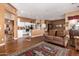 Spacious kitchen features hardwood floors, an island, and white cabinets at 9048 E Cedar Waxwing Dr, Sun Lakes, AZ 85248