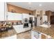 Modern kitchen with granite counters, stainless steel appliances, and white cabinets at 9048 E Cedar Waxwing Dr, Sun Lakes, AZ 85248