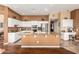 Bright kitchen with white cabinets, granite island, and stainless steel appliances at 9048 E Cedar Waxwing Dr, Sun Lakes, AZ 85248