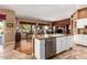 Open kitchen features granite island, stainless steel appliances, and hardwood floors at 9048 E Cedar Waxwing Dr, Sun Lakes, AZ 85248
