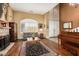 Elegant living room with hardwood floors, fireplace, and a cozy seating area at 9048 E Cedar Waxwing Dr, Sun Lakes, AZ 85248