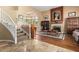 Spacious living room with hardwood floors, fireplace, and large windows at 9048 E Cedar Waxwing Dr, Sun Lakes, AZ 85248