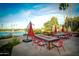 Relaxing patio seating area with fire pit and scenic water views at 9048 E Cedar Waxwing Dr, Sun Lakes, AZ 85248