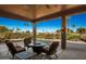 Covered patio with seating area and fire pit overlooking golf course at 9048 E Cedar Waxwing Dr, Sun Lakes, AZ 85248