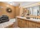 Bathroom with double vanity, bathtub, and terracotta tile at 9250 E Whitethorn Cir, Scottsdale, AZ 85266