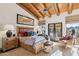 Spacious bedroom with wooden furniture and access to a patio at 9250 E Whitethorn Cir, Scottsdale, AZ 85266
