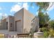 Tan stucco exterior, two-car garage, and desert landscaping at 9250 E Whitethorn Cir, Scottsdale, AZ 85266