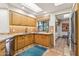 Kitchen with wood cabinets, granite counters, and tile floors at 9250 E Whitethorn Cir, Scottsdale, AZ 85266
