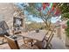 Outdoor patio with dining table, seating, and built-in grill, offering a relaxing space at 9250 E Whitethorn Cir, Scottsdale, AZ 85266