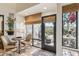 Bright sunroom features a bistro set and access to a patio at 9250 E Whitethorn Cir, Scottsdale, AZ 85266